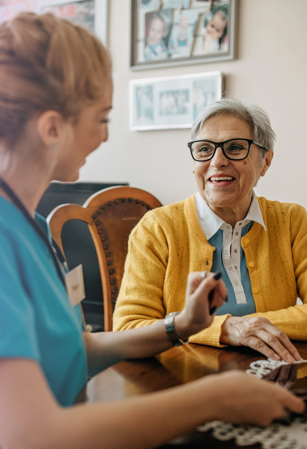 In-home Caregiver chatting with an elderly woman