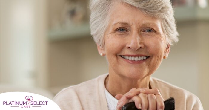 An older woman with healthy teeth smiles, representing good dental hygiene